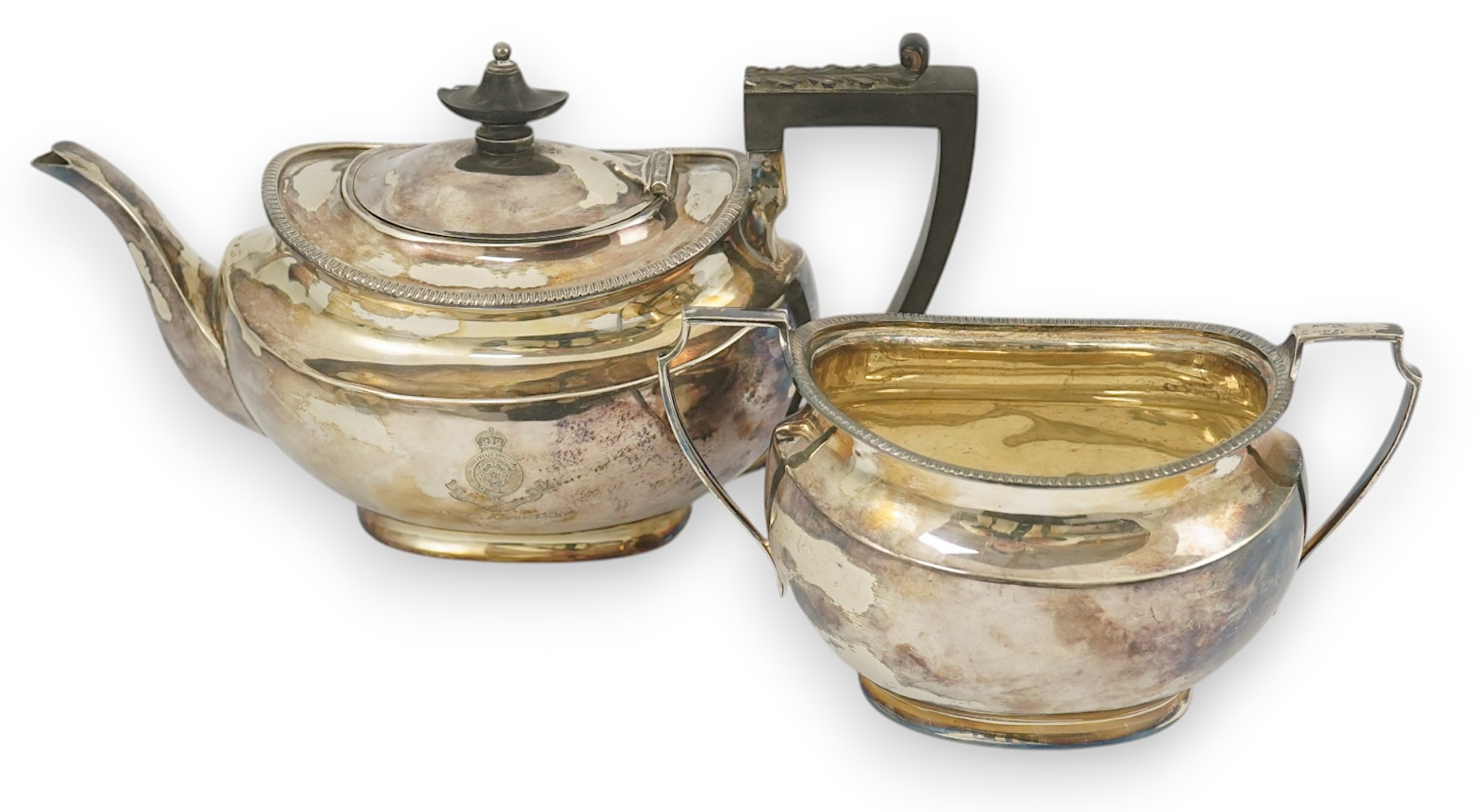 An Edwardian silver teapot and a matching sugar bowl, with engraved inscription, relating to the Royal Fusiliers, by Atkin Brothers